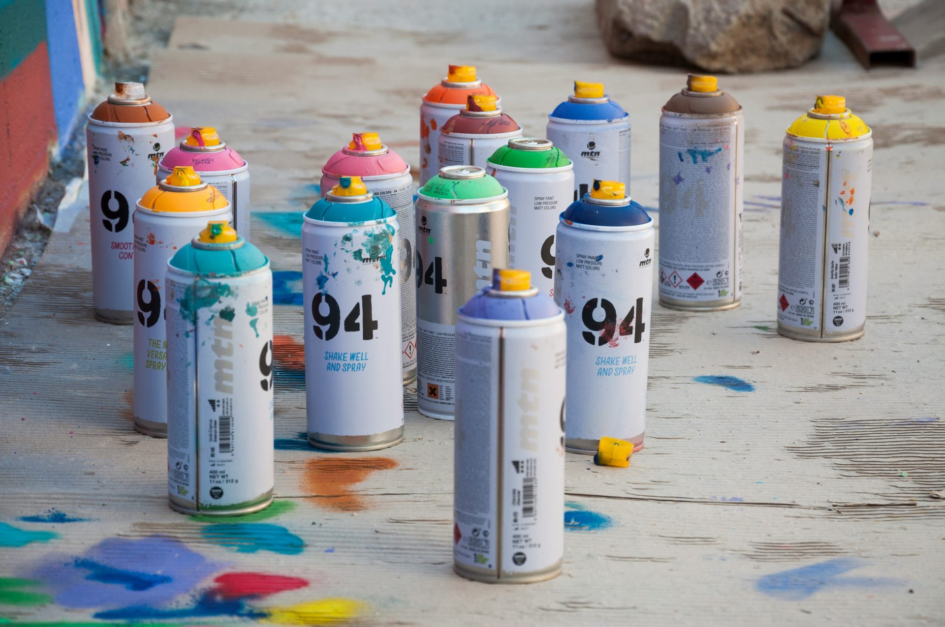 a group of spray paint cans sitting on the ground