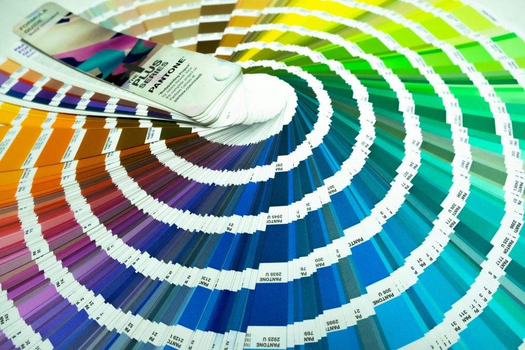 a pan of paint with a brush on top of it